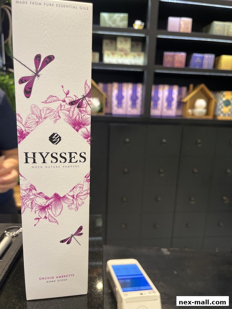 A tall box for HYSSES home scent with orchid and dragonfly design.