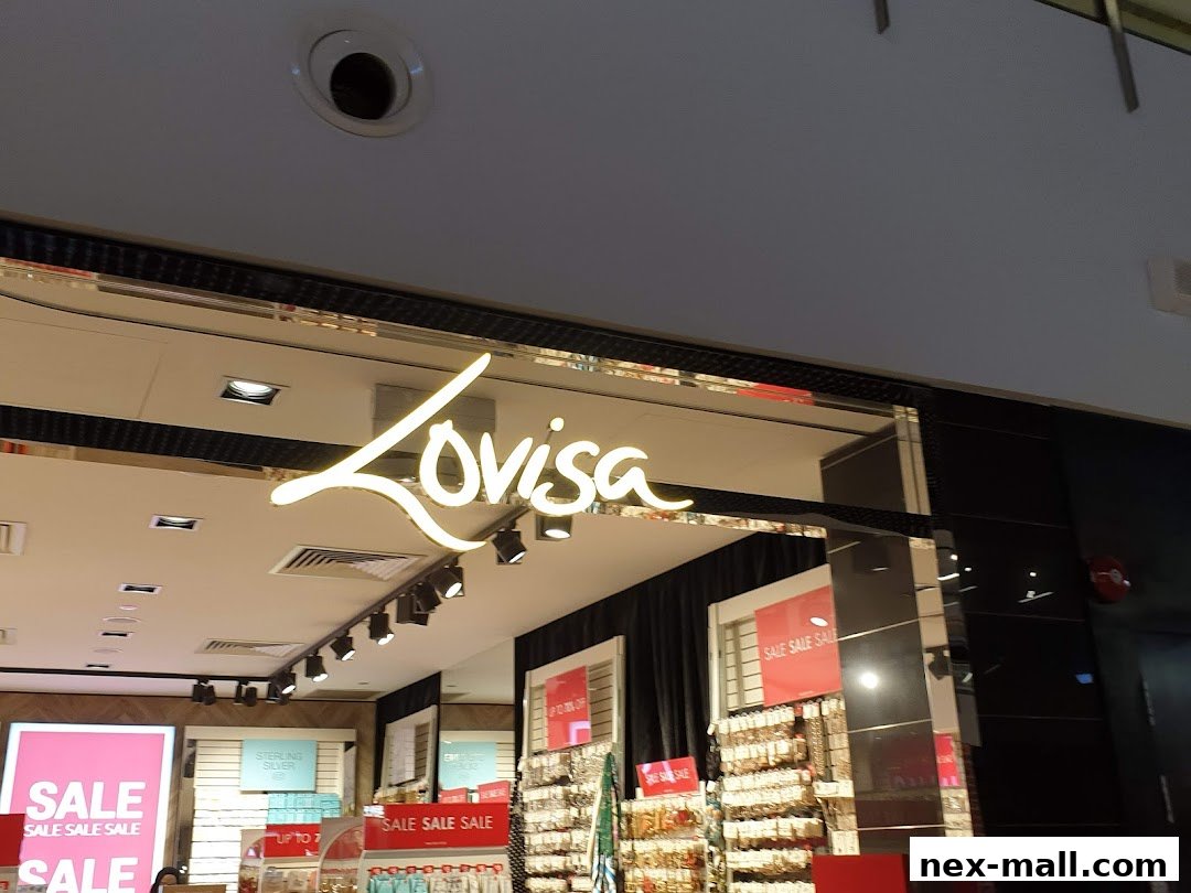 The illuminated Lovisa logo above a store with sale signs and jewelry displays.