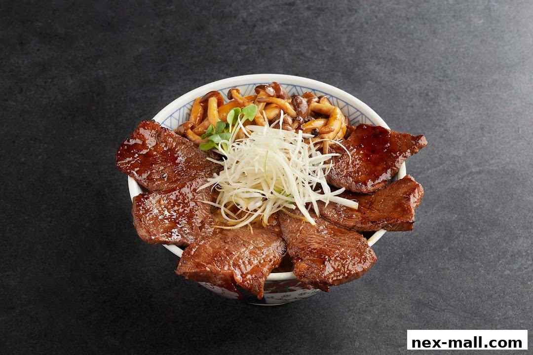 A close-up of a delicious beef and mushroom rice bowl from Aburi-EN Nex.