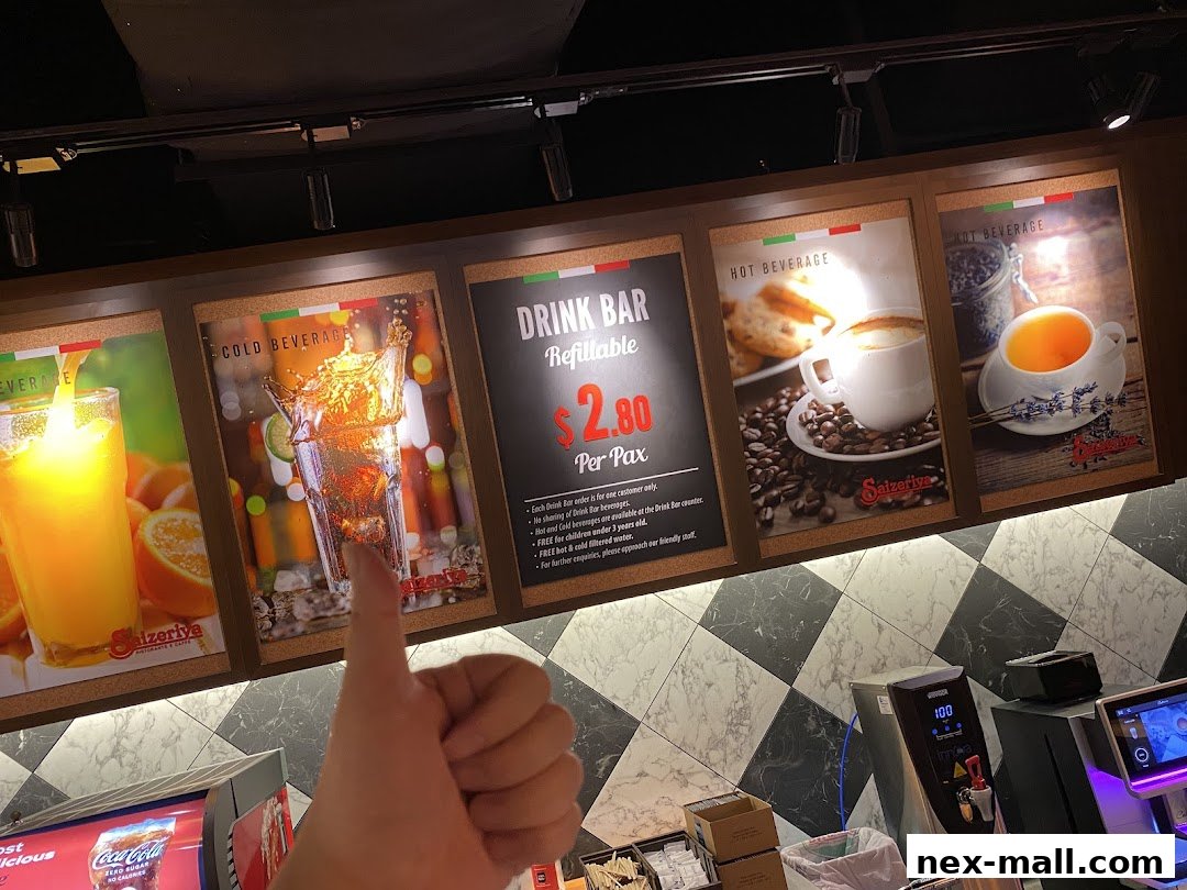 A display of drinks and a drink bar offer at Saizeriya, with a thumbs-up gesture.