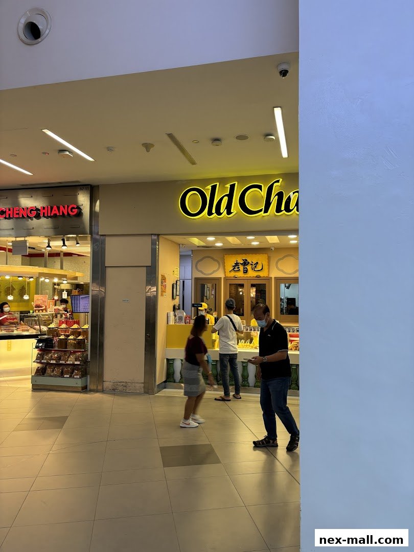 People are seen entering and exiting the Old Chang Kee shop in a mall.