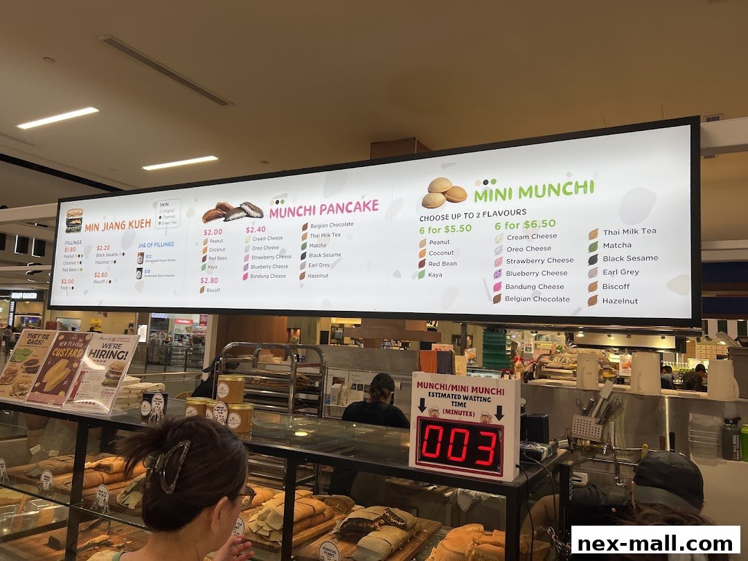 A menu board displaying various pancake and mini munchi flavors and prices.