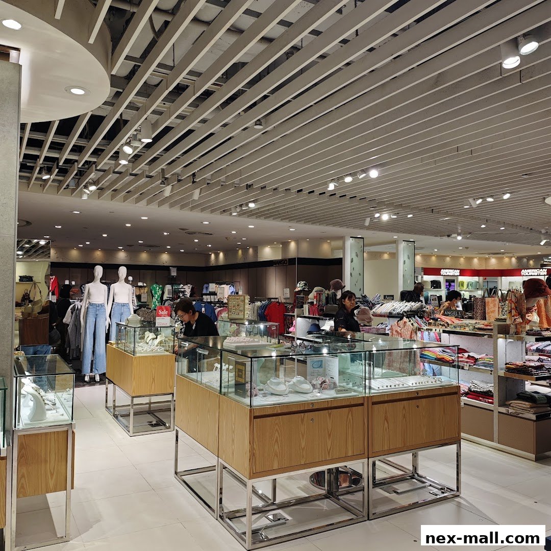Interior view of a well-lit department store with clothing displays and jewelry counters.