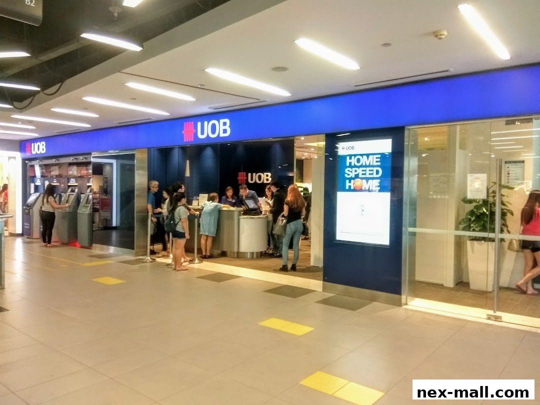 The UOB Serangoon Central Branch features ATMs and a customer service counter with people queuing.