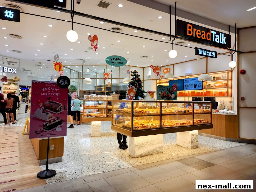 BreadTalk bakery shop interior with display cases full of bread and pastries, decorated for Christmas.