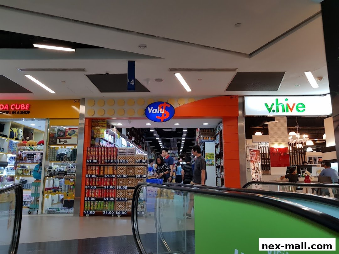 The Valu shop entrance with displays of various products and prices visible.
