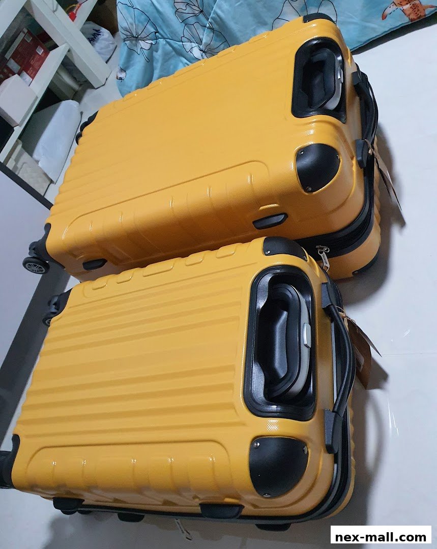 Two bright yellow suitcases with black accents are displayed.