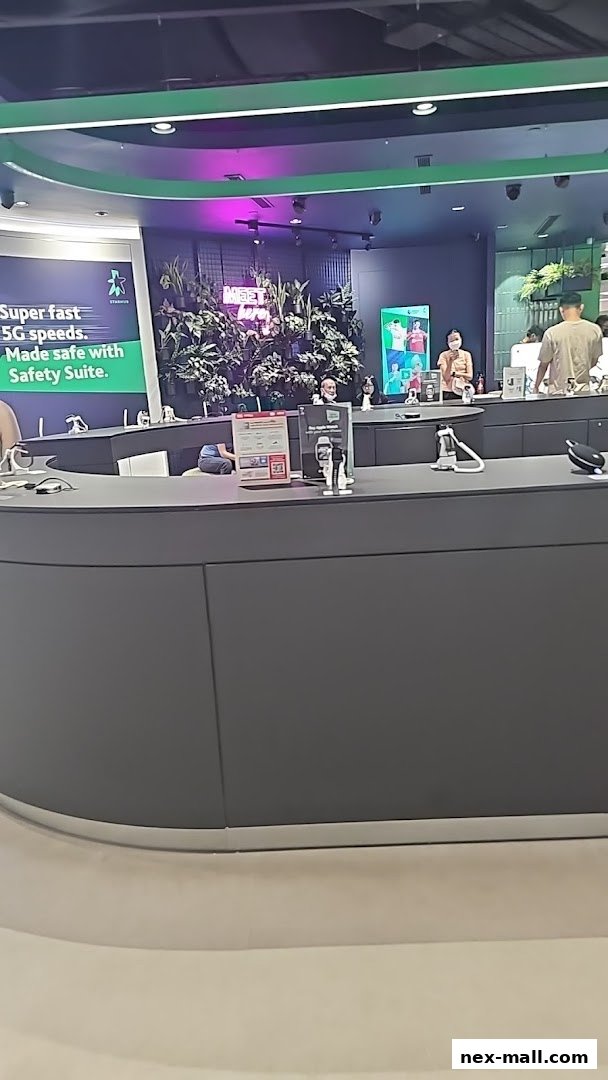 Interior of a StarHub shop with staff and customers at the counter.