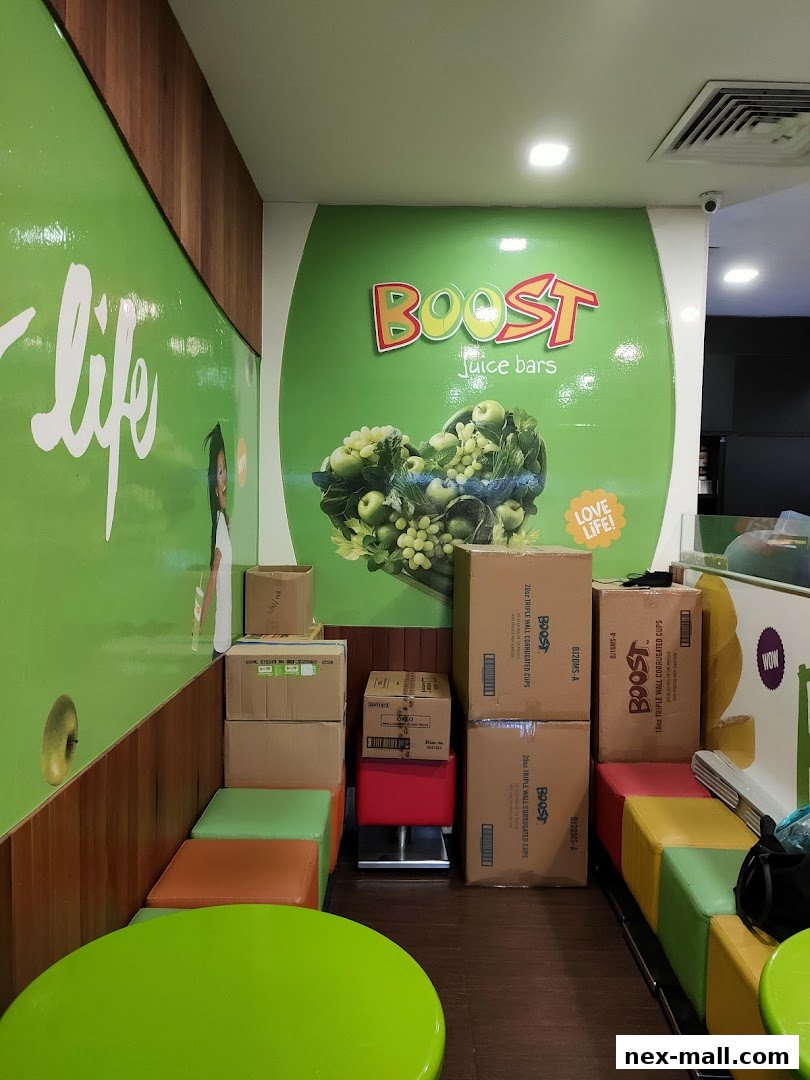 Interior of a Boost Juice bar with colorful seating and stacked boxes.
