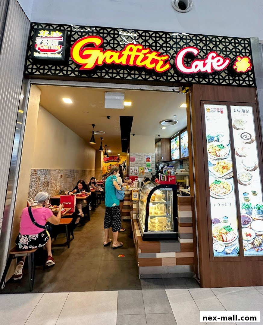 The entrance of Graffiti Cafe, showcasing its vibrant signage and interior seating with customers.