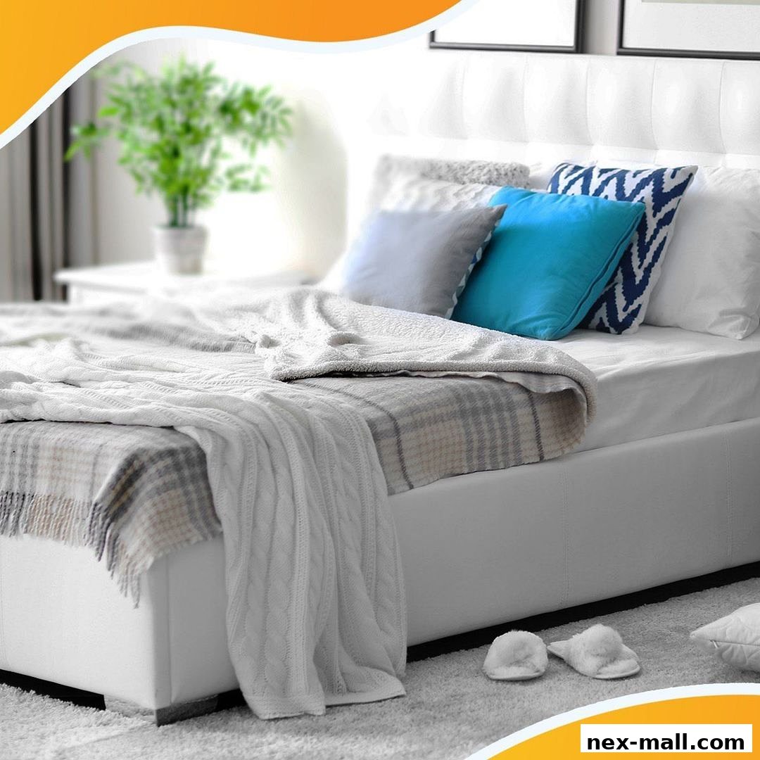 A beautifully made bed with white linens, colorful pillows, and cozy blankets.