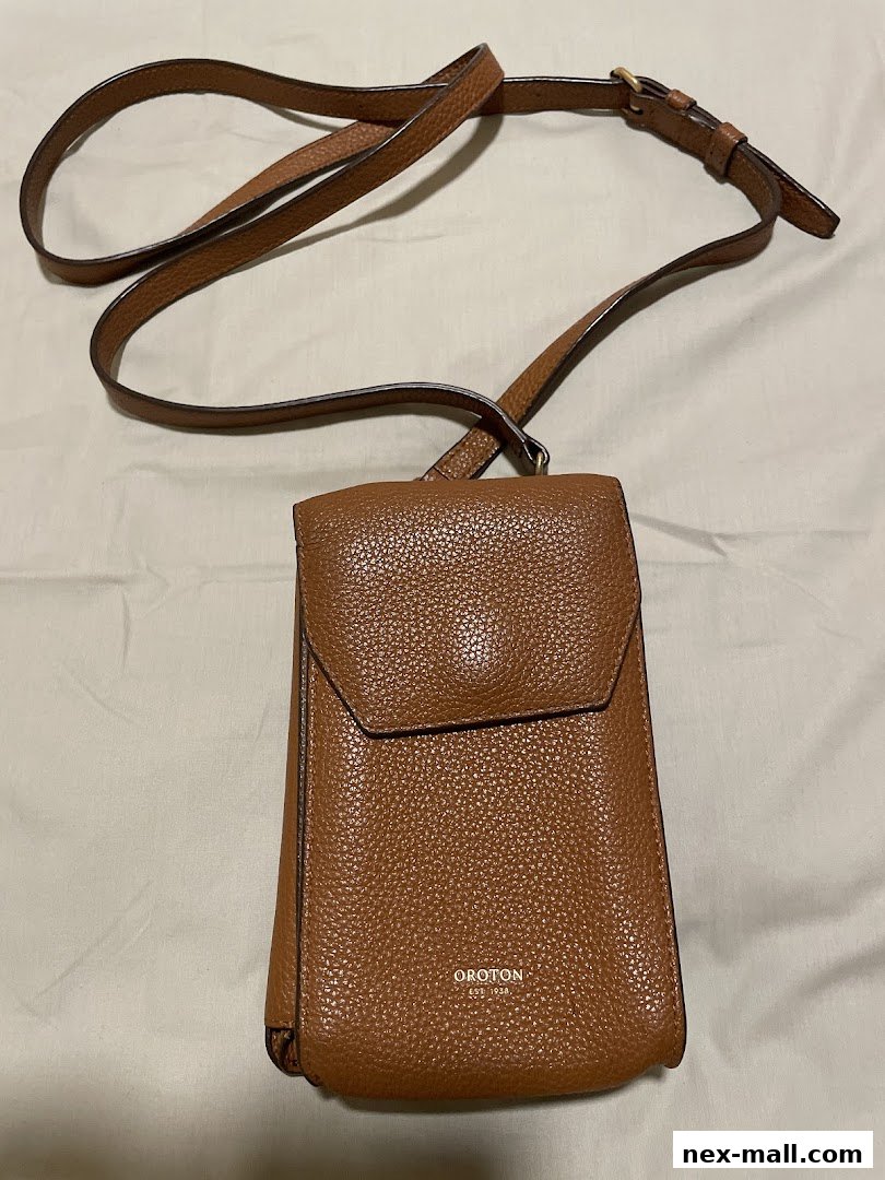 A brown leather crossbody bag with a long strap and a flap closure.