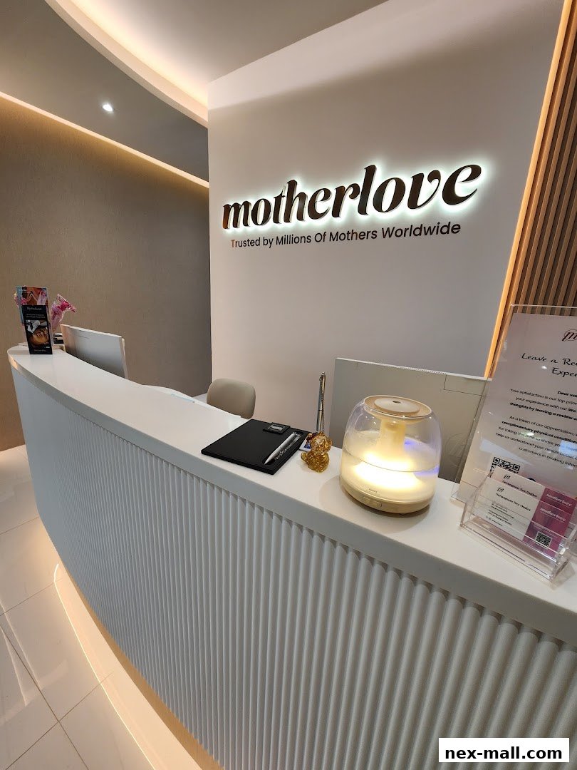 The reception desk of Motherlove Nex, featuring a modern design and the brand's illuminated logo.