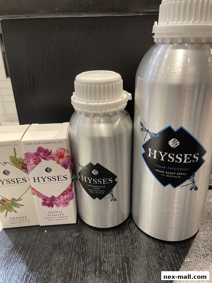 A display of HYSSES essential oils and home scent refills in various sizes.