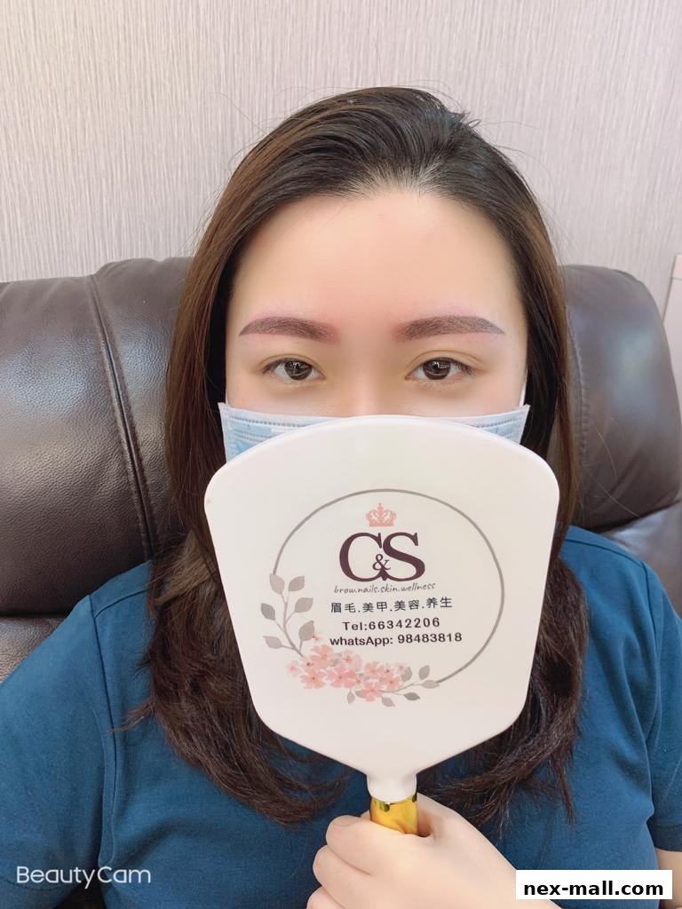 A woman holds a mirror with the CS Beauty logo and contact information.