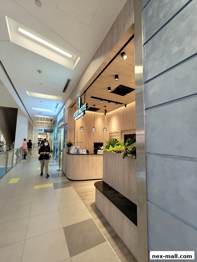 The entrance of FootNote Reflexology, a clean and modern spa with wooden accents and plants.