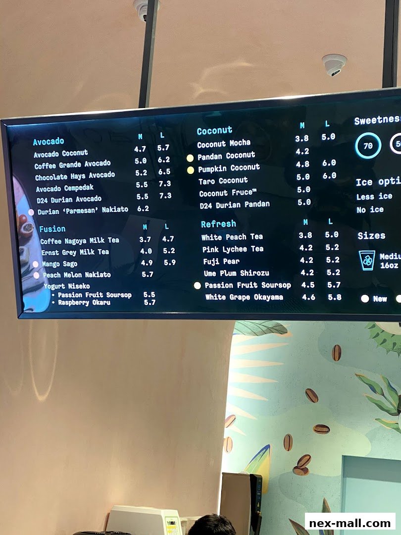 A digital menu board displaying various drinks with prices and sizes.