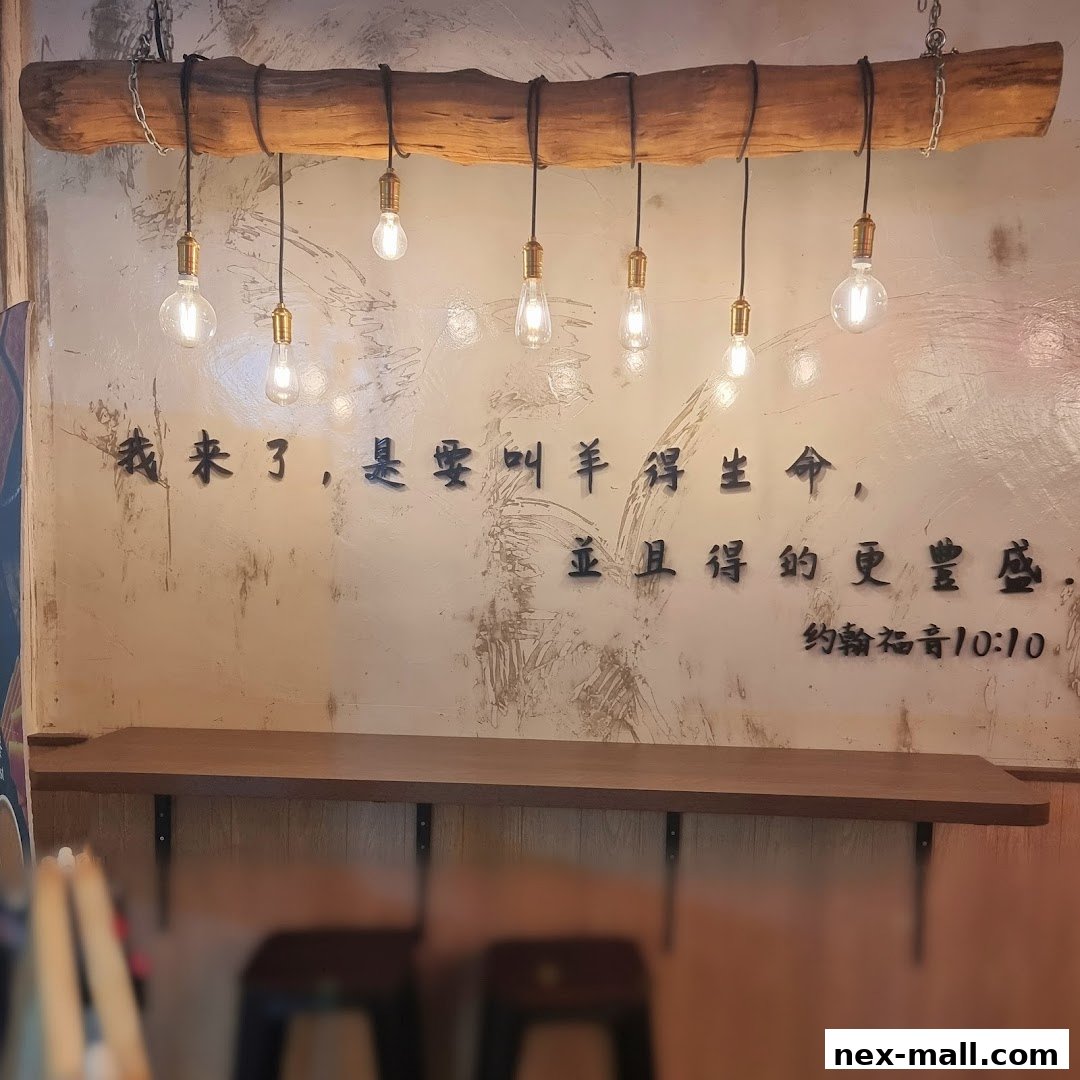 A rustic wooden beam with hanging Edison bulbs above a shelf with Chinese calligraphy.