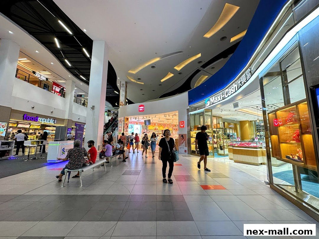 A view of the Maxi-Cash store entrance and display windows in a shopping mall.