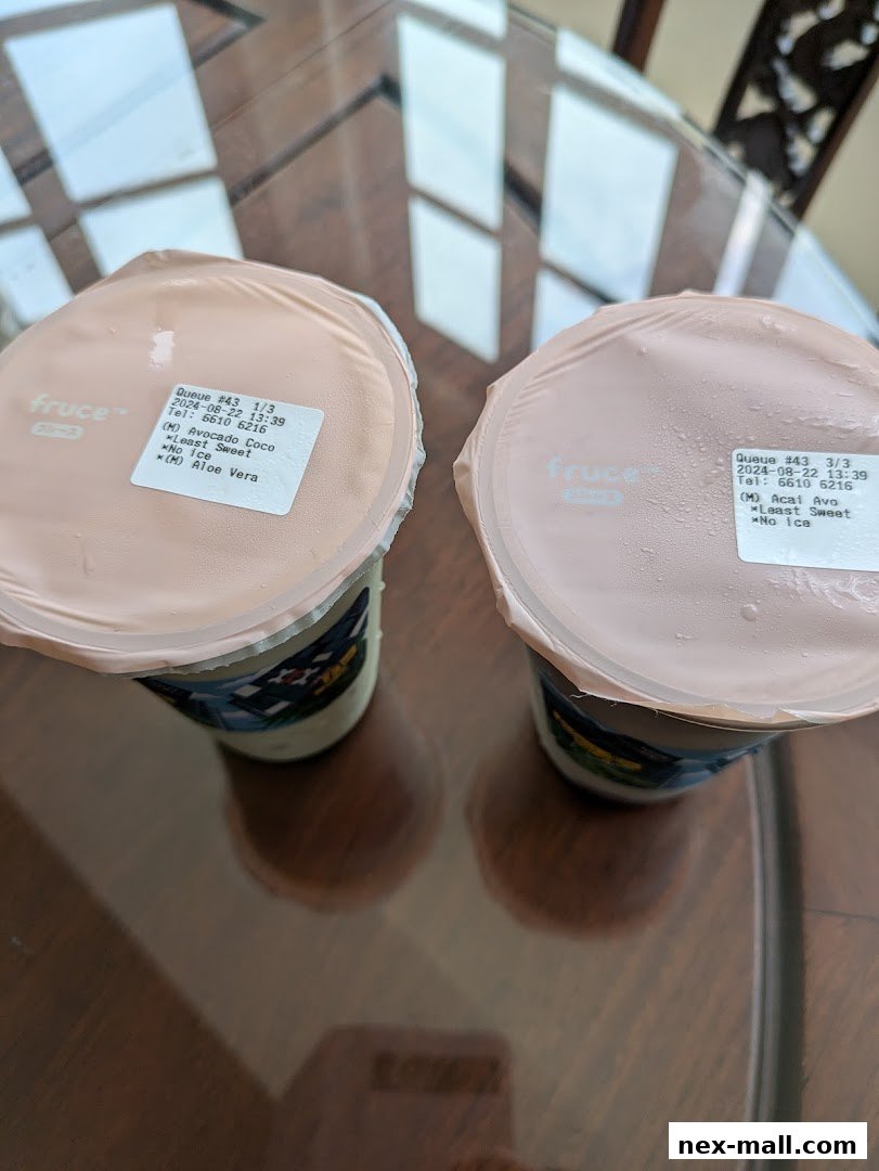 Two Fruce drinks with custom labels showing order details and ingredients.