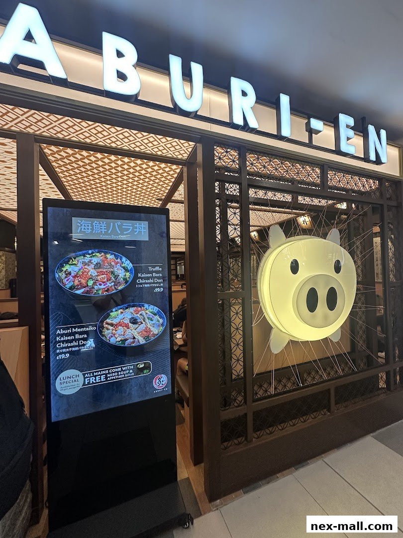 The entrance of Aburi-EN Nex, featuring a digital menu and a pig-shaped light.