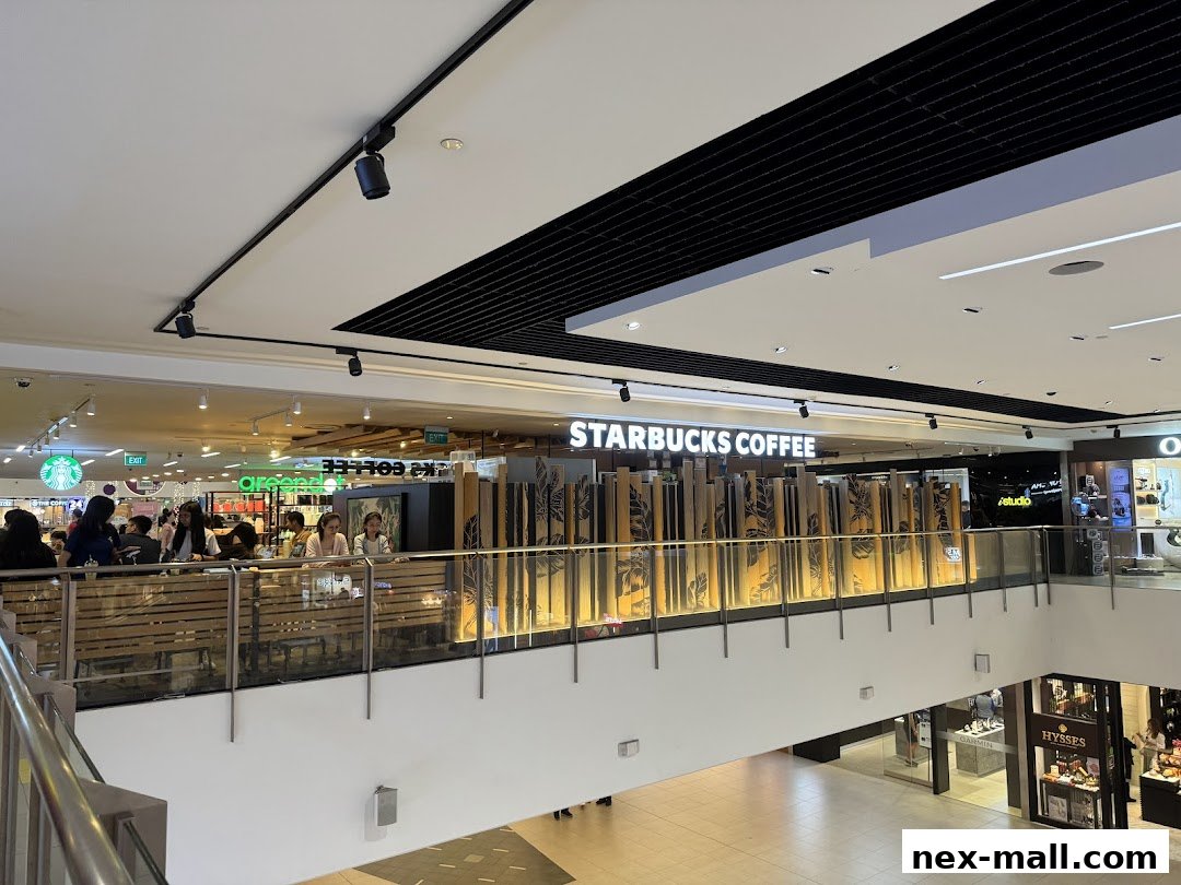 Interior view of a Starbucks coffee shop with customers seated at tables.