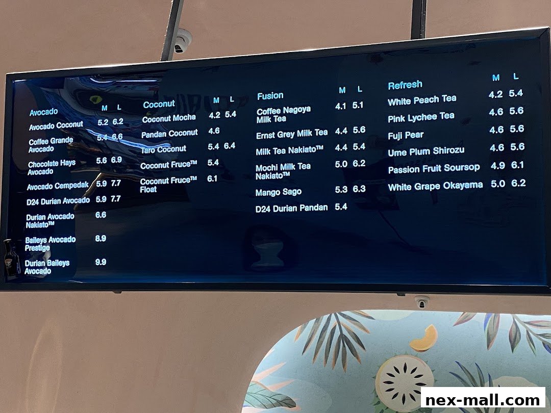 A digital menu board displaying a variety of drinks with prices for different sizes.