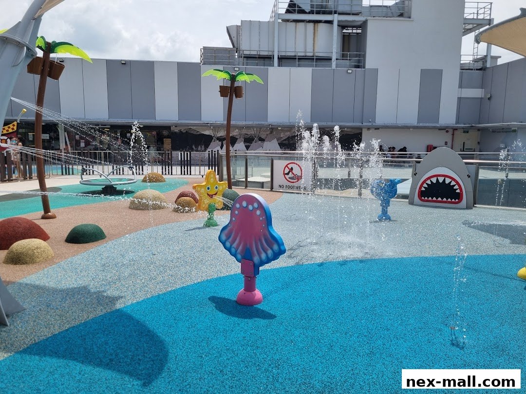 A vibrant water play area with colorful sea creature-themed sprinklers and a shark feature.