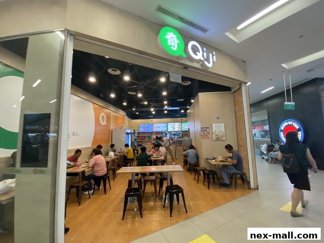 Interior view of the Qi Ji restaurant with customers dining at tables.