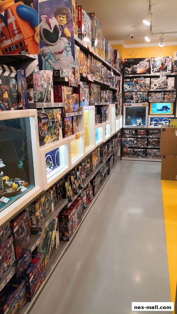Interior view of a LEGO store with shelves stocked with various LEGO sets.