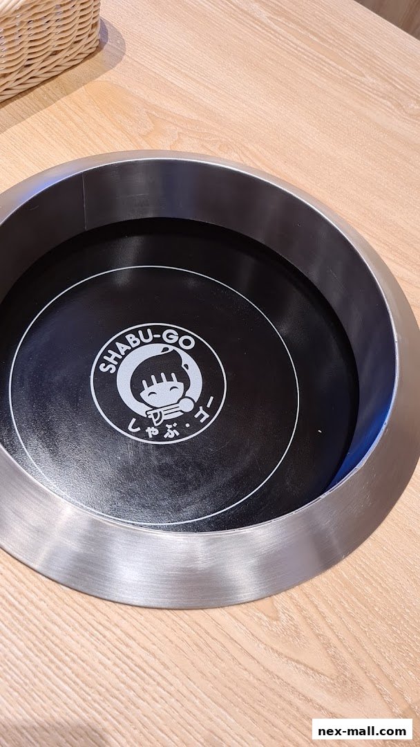 A close-up of a built-in hot pot cooker with the SHABU-GO logo.