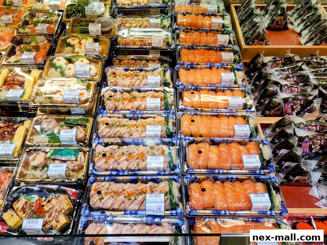 A display of various pre-packaged sushi and onigiri, featuring salmon and other Japanese delicacies.