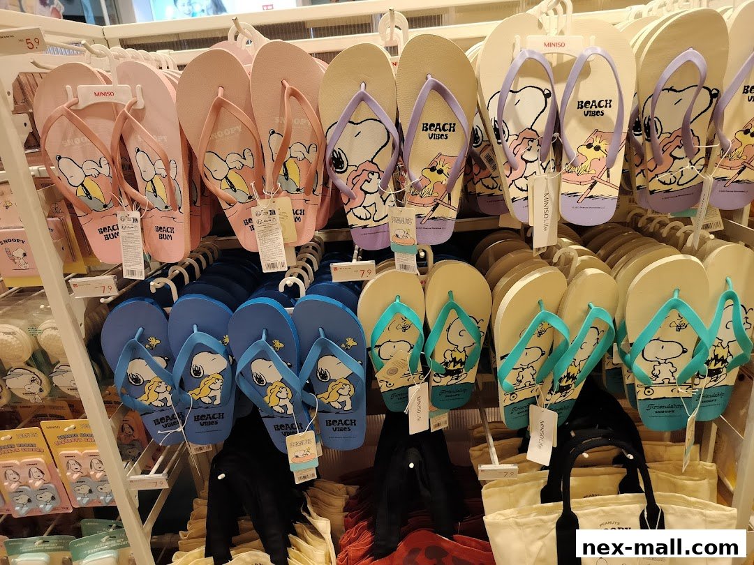 A display of Snoopy-themed flip-flops in various colors and designs.