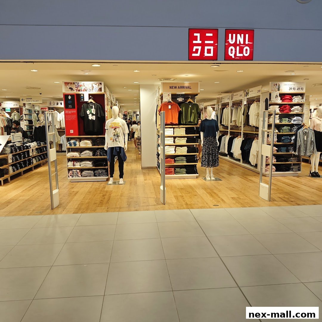 The entrance of a UNIQLO store showcasing new arrivals and various clothing displays.