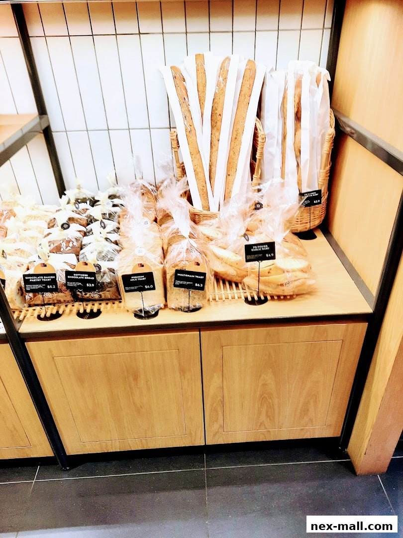 A display of freshly baked bread and pastries at Paris Baguette NEX.