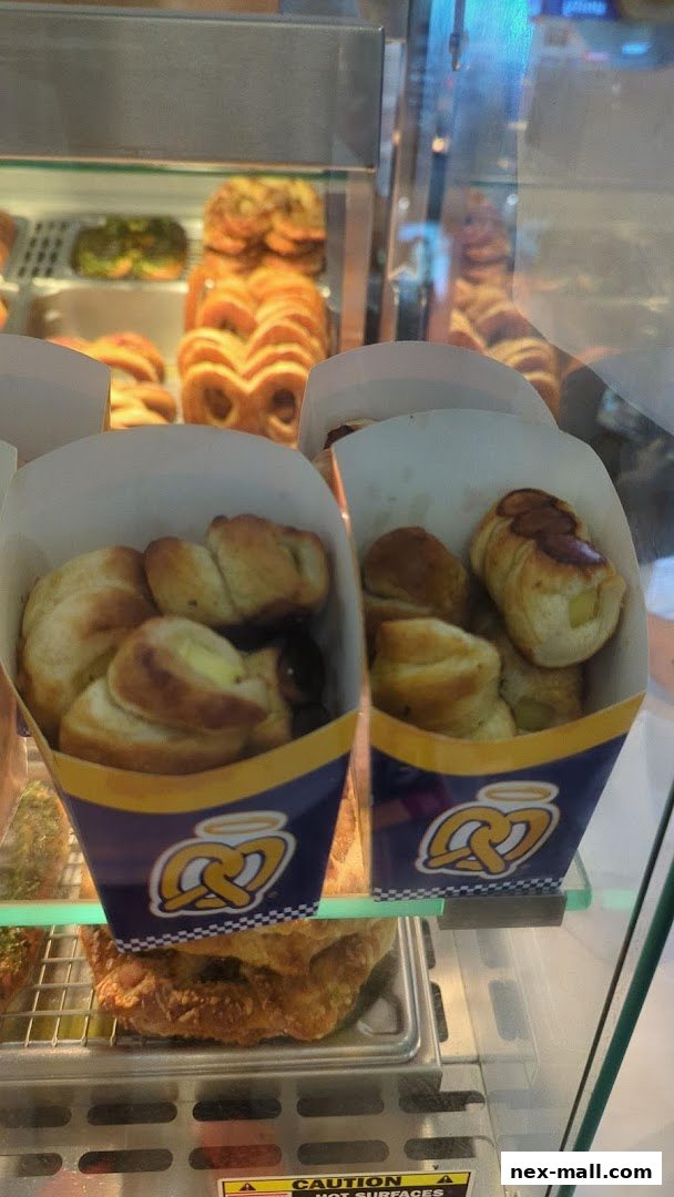 Two containers of Auntie Anne's pretzel bites displayed in a glass case.