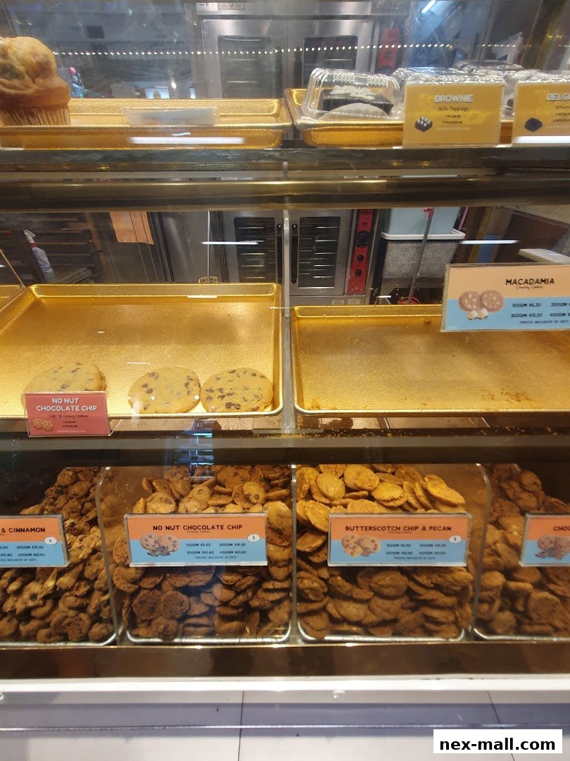 A display case filled with various cookies and baked goods from Famous Amos.