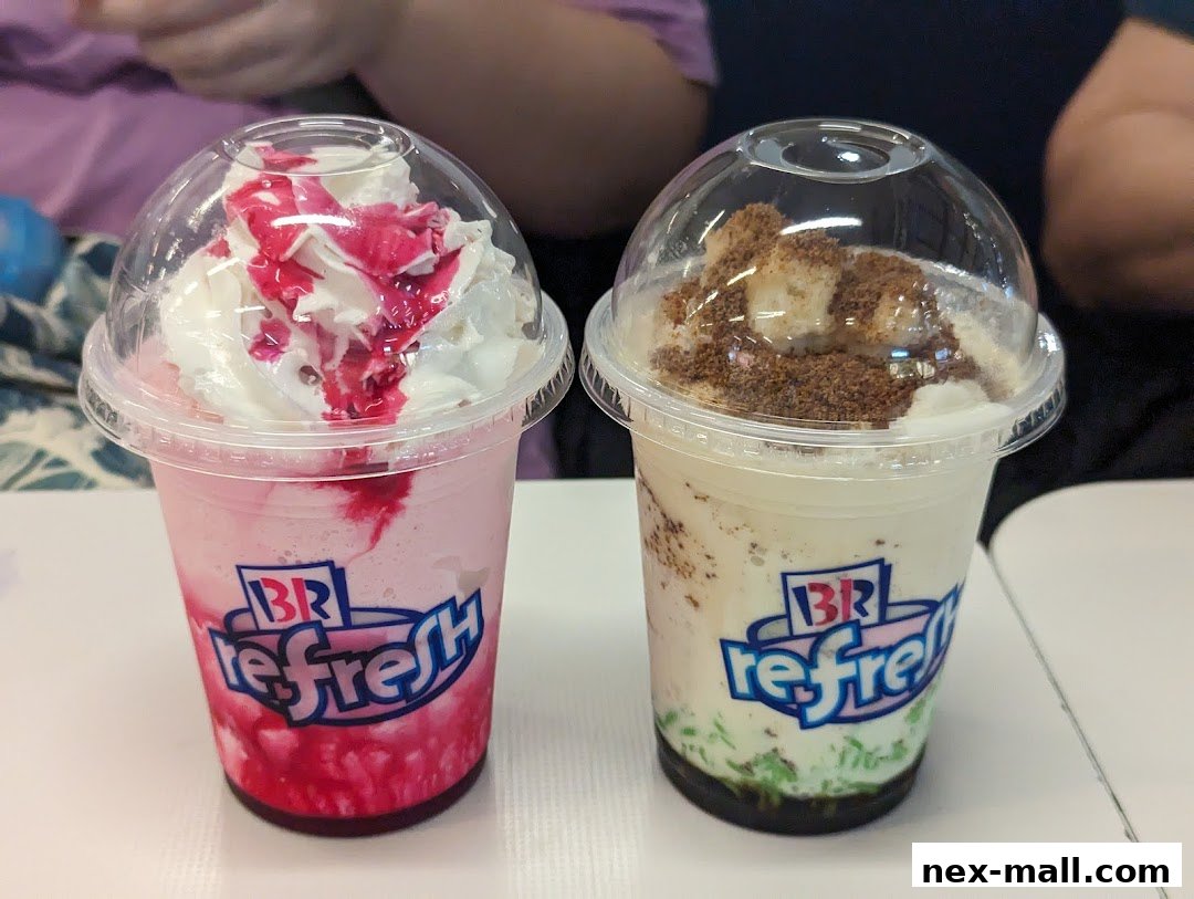 Two refreshing Baskin-Robbins drinks with whipped cream and toppings.