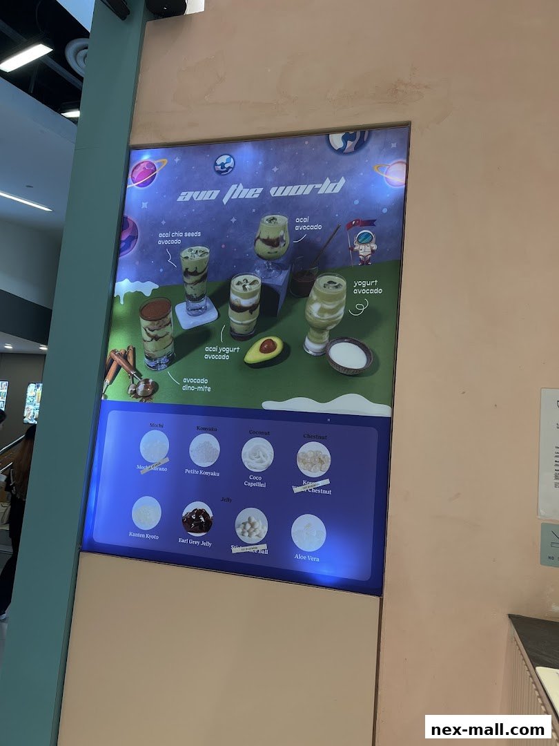 A digital menu board displaying various avocado-based drinks and toppings.