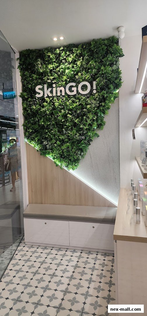 Interior of a modern beauty shop with a green wall and product displays.