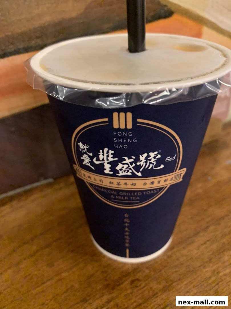 A close-up of a dark blue cup with the Fong Sheng Hao logo and text.