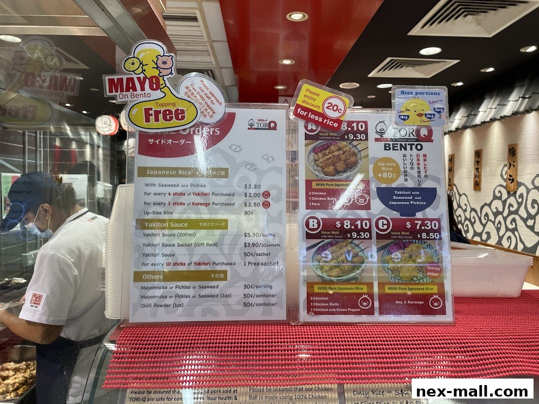 A menu board for TORI-Q featuring bento boxes, yakitori, and side orders with prices.