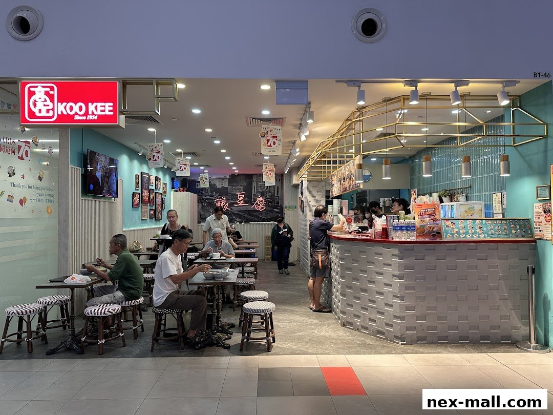 Koo Kee restaurant interior with customers dining and a counter service area.