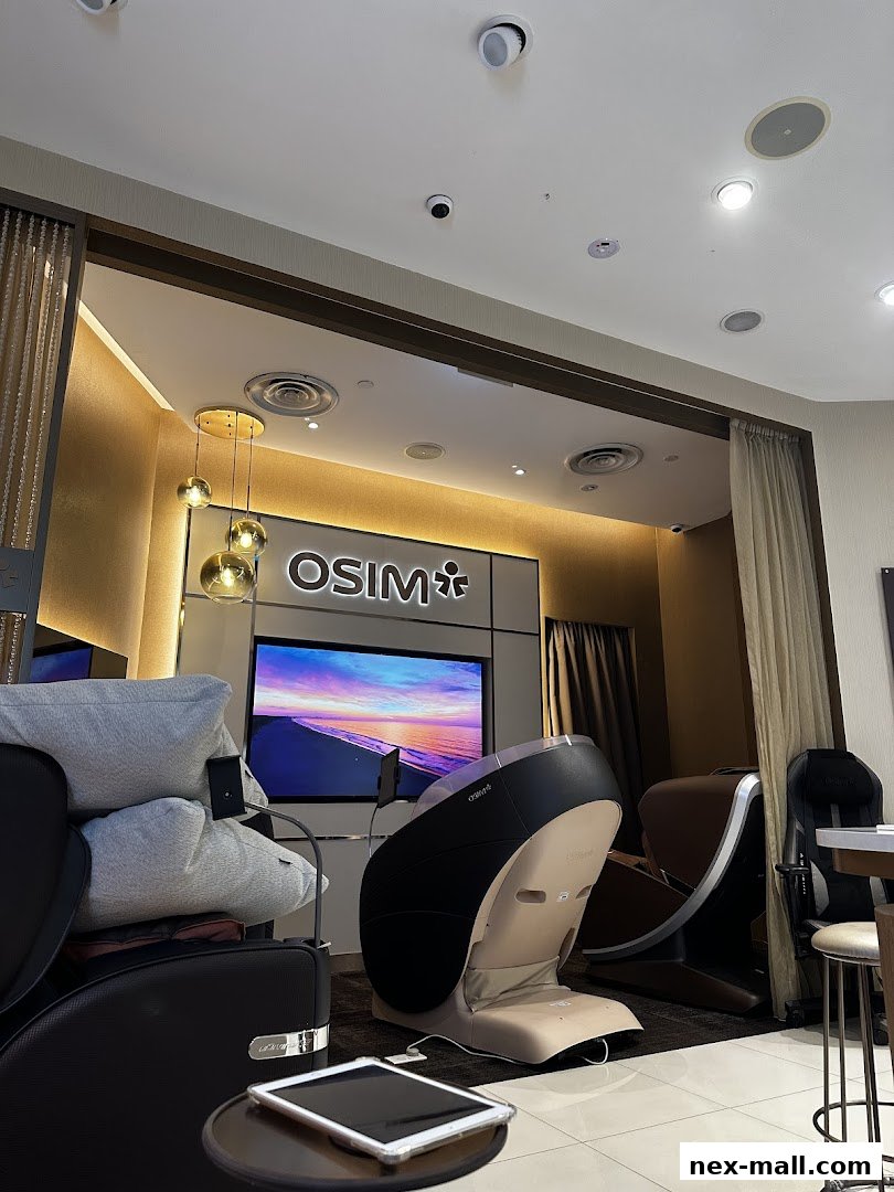 Interior of an OSIM Nex store featuring massage chairs and a large screen.