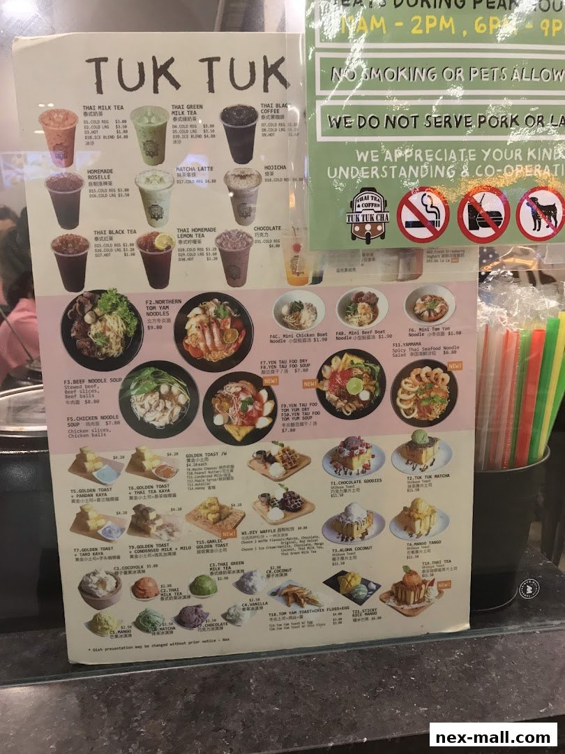 A menu board displaying various Thai beverages, noodle soups, toasts, and desserts with prices.