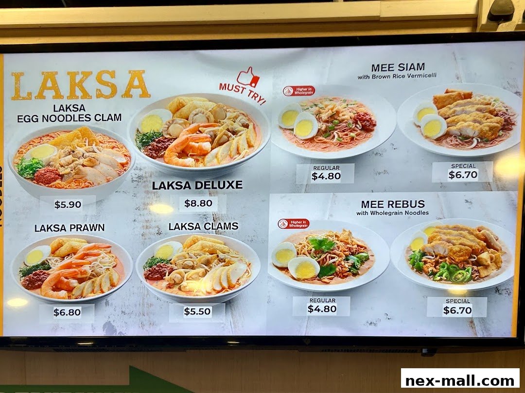 A menu board displaying various Laksa, Mee Siam, and Mee Rebus dishes with prices.