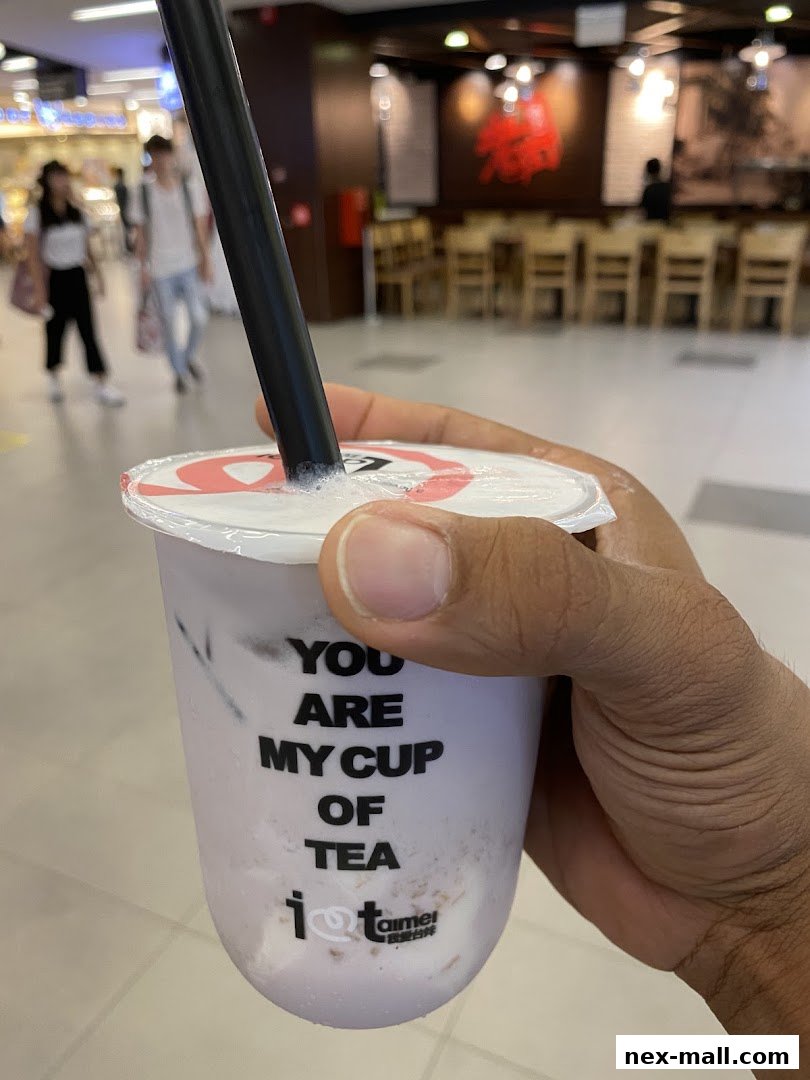 A hand holds a purple bubble tea with the phrase 'You are my cup of tea'.