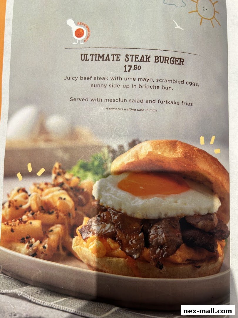 A close-up of the Ultimate Steak Burger with fries, featuring a sunny-side-up egg.