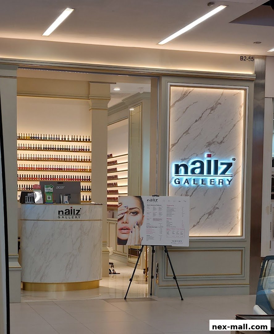 The entrance of Nailz Gallery NEX, showcasing a reception desk and a display of nail polish bottles.