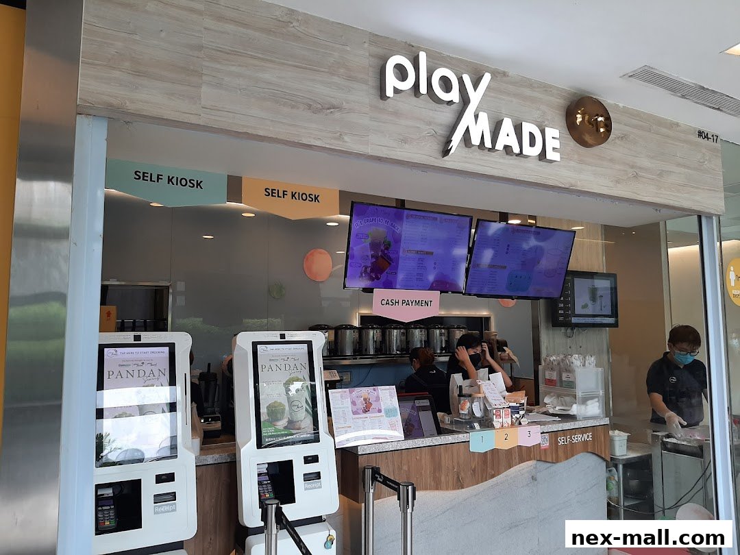 The PlayMade shop front features self-service kiosks, digital menus, and a counter with staff.